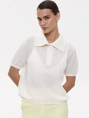 Woman wearing a white short-sleeve shirt with a collar on a plain background