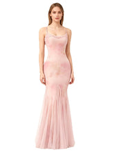 Model wearing a spaghetti strap lace trim fishtail tulle gown in a soft pink hue.