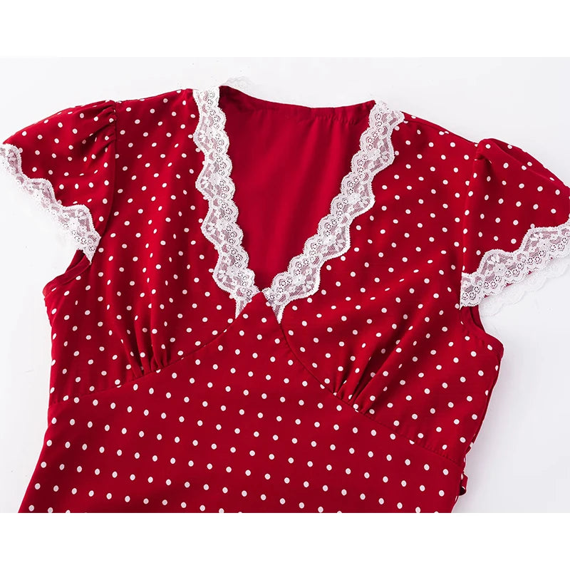 Red polka dot dress with lace trim on a white background