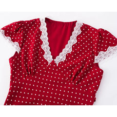 Red polka dot dress with lace trim on a white background