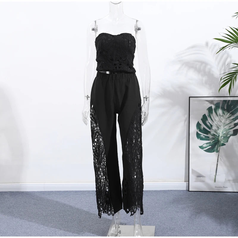 Black lace strapless top and pants on a mannequin against a white wall with a plant in the corner.