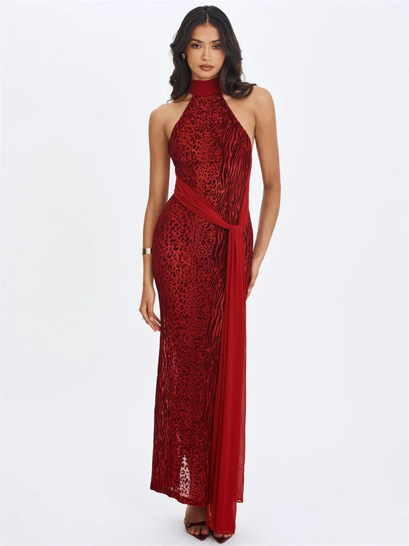 Woman wearing a red lace halter neck gown on a white background