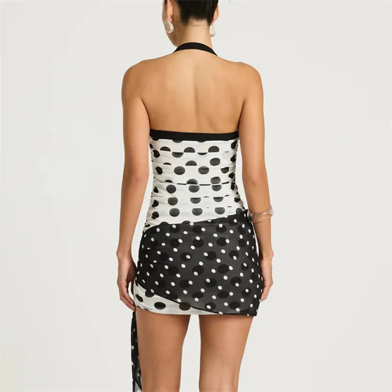 Black and white polka dot dress on a plain background
