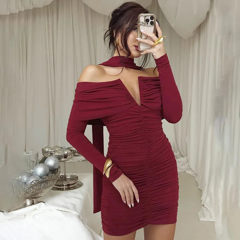 Woman taking a mirror selfie wearing a burgundy off-shoulder dress.