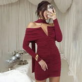 Woman taking a mirror selfie wearing a burgundy off-shoulder dress.