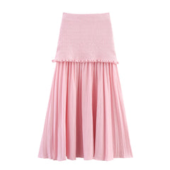 Pink skirt with a textured top and pleated skirt on a white background