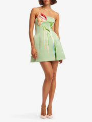 Full body view of strapless mini dress with floral appliqué