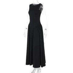 Black sleeveless dress on a mannequin against a white background