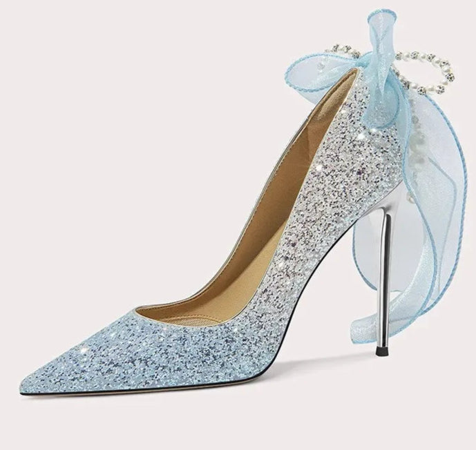 Sparkly high-heeled shoe with a decorative bow on a white background