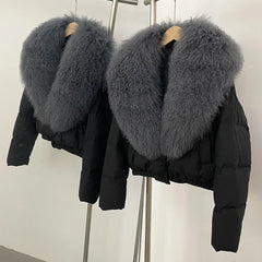 Black cropped puffer jacket with a large grey fur collar.