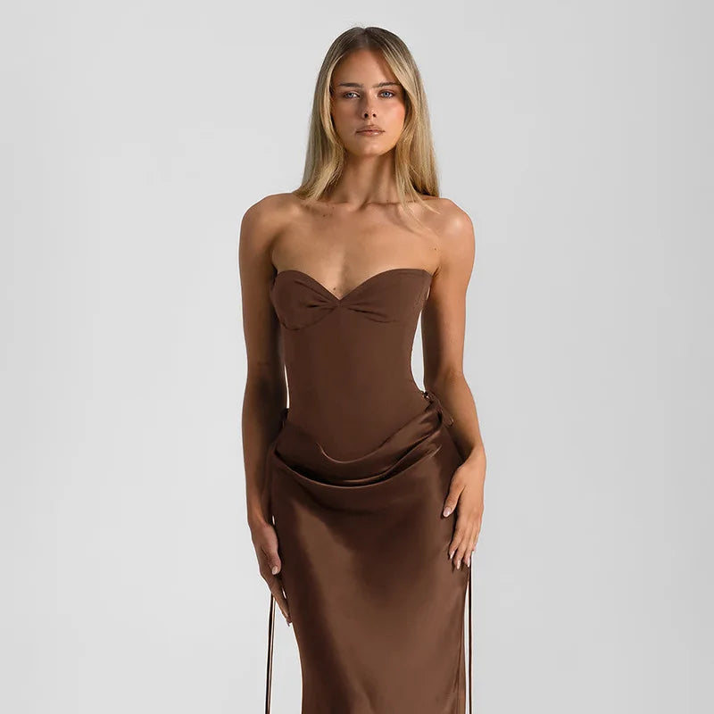 Woman wearing a brown strapless dress against a plain background