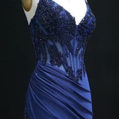 Blue evening gown with intricate beading on a black background