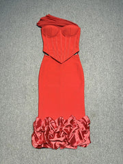 Red strapless dress with ruffled bottom on a gray background