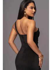 Woman wearing a black dress with a gray background