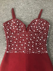 Red dress with white bead embellishments on a gray background