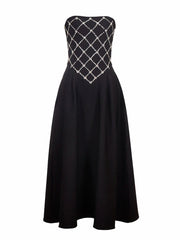 Black strapless dress with silver embellishments on a white background