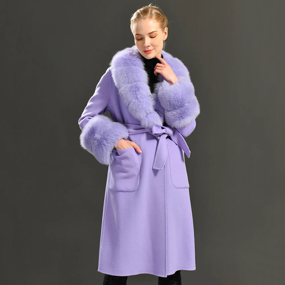 Woman wearing a light purple coat with fur collar and cuffs on a dark background