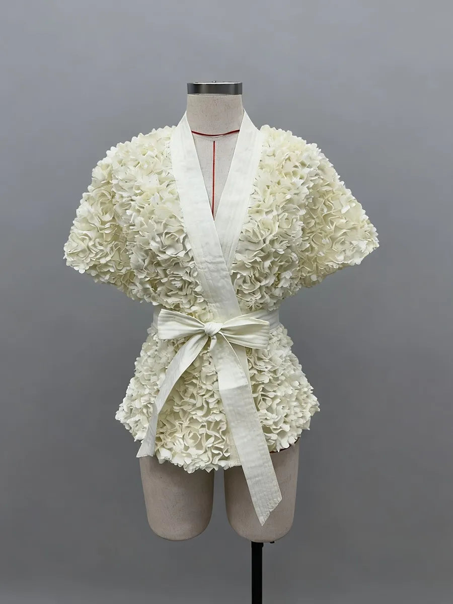 White floral dress on a mannequin against a gray background