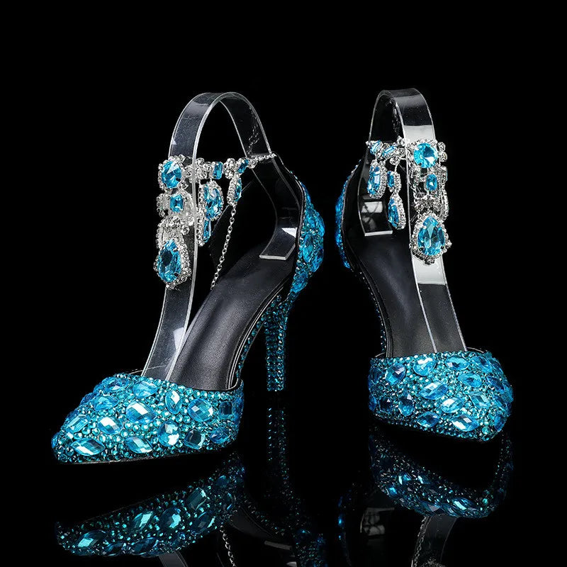 High-heeled shoes with blue gemstones on a black background