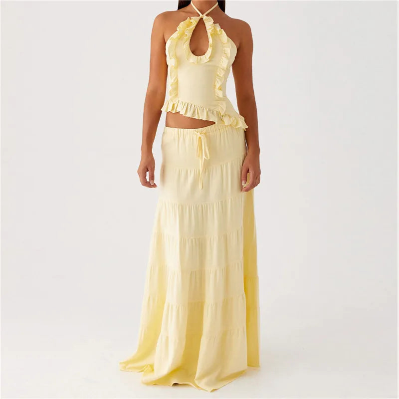 Yellow dress with ruffled top and long skirt on a white background