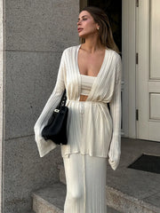 Woman in a stylish outfit standing outside a building