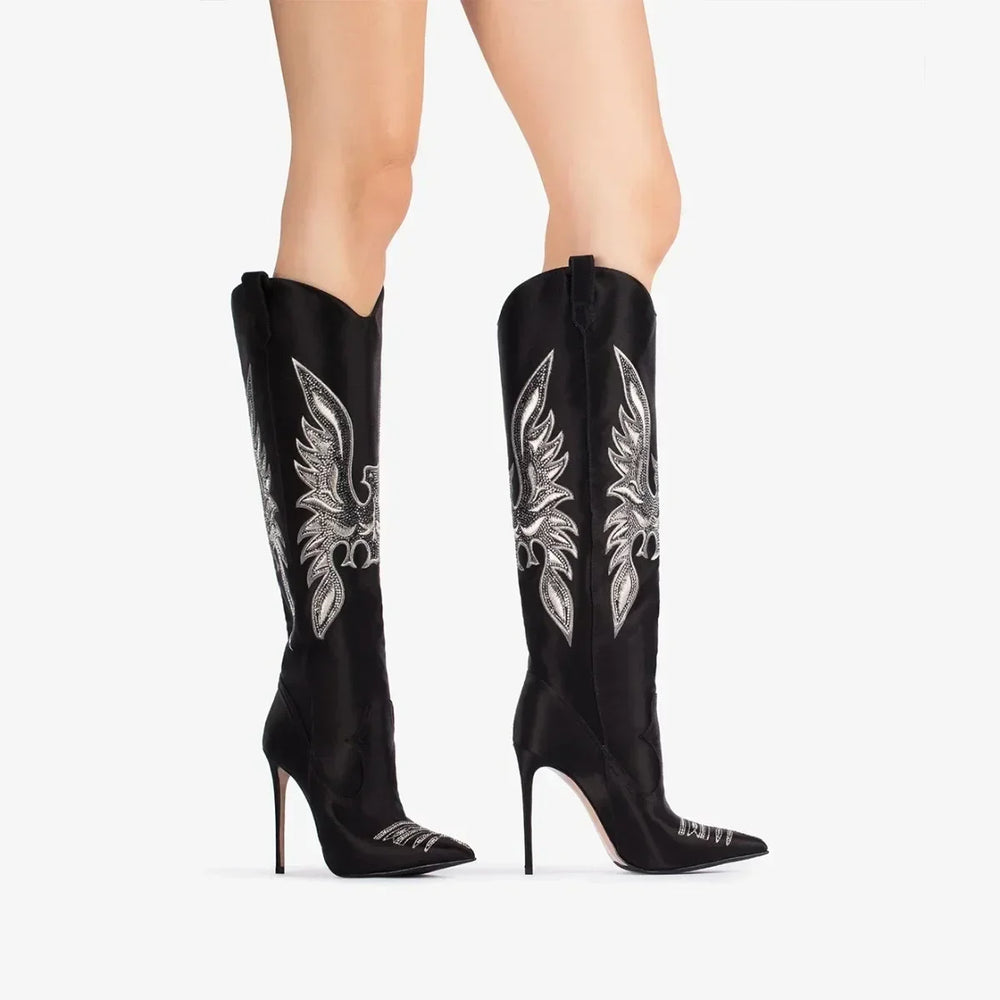 Black embroidered pointed stiletto cowboy boots on model