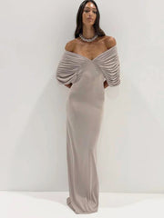 Woman wearing a ruched off-shoulder v-neck maxi dress.