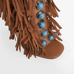 Fringed turquoise studded knee-high boots, back view showing zipper and heel