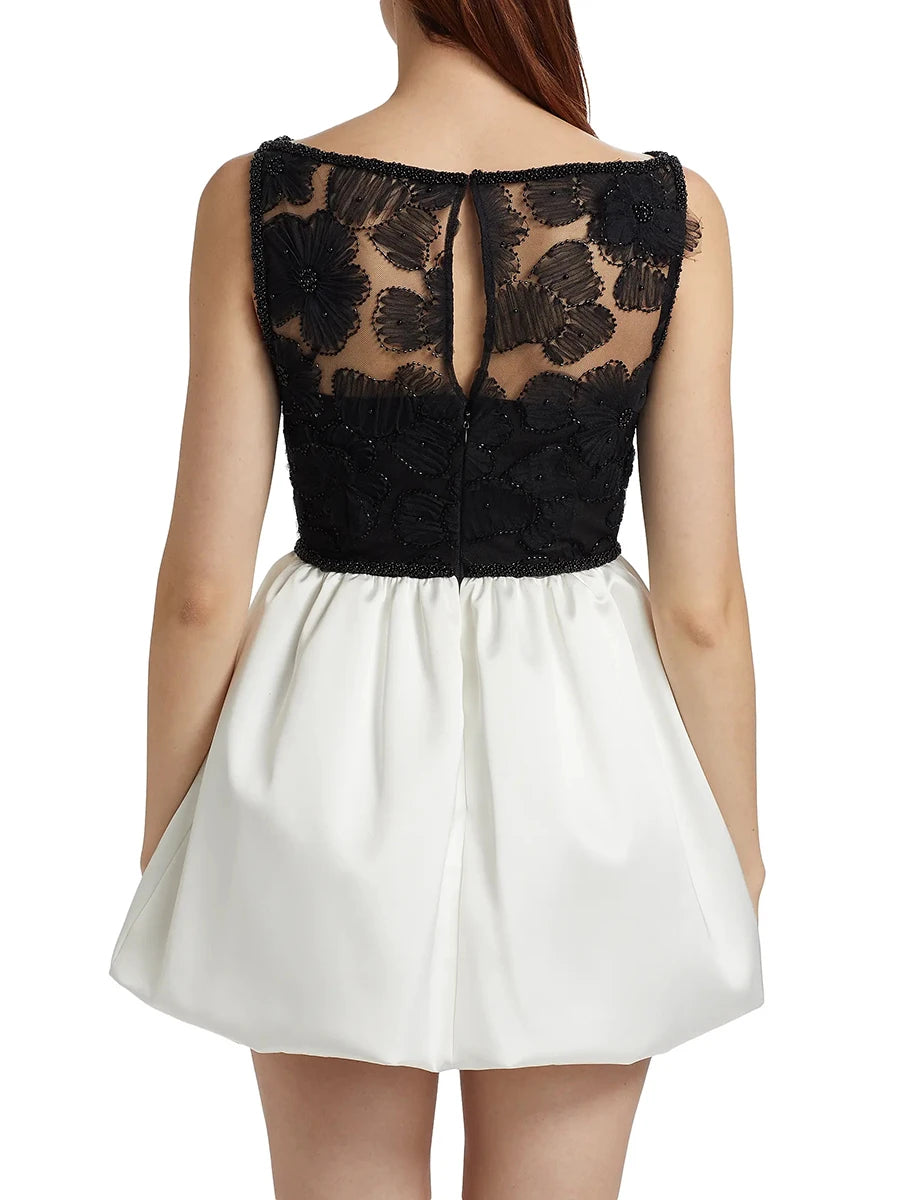 Black lace top and white skirt dress on a white background
