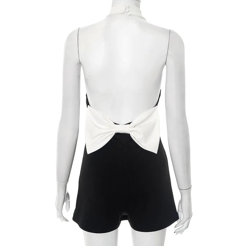 Mannequin wearing a black and white outfit with a bow detail on a white background