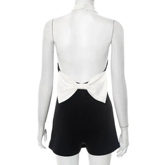 Mannequin wearing a black and white outfit with a bow detail on a white background