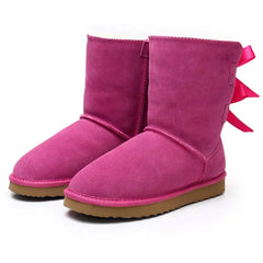Pink plush snow boots with ribbon bow detail