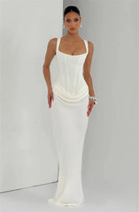 Woman wearing a white evening gown against a plain background