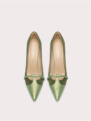 Pair of green high-heeled shoes on a white background