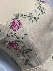 Embroidered floral design on a beige fabric background
