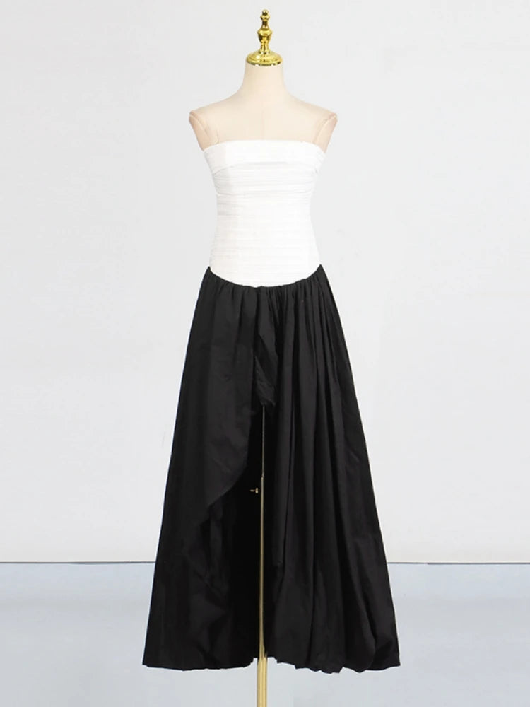 Mannequin wearing a white strapless top and black wide-leg pants on a white background