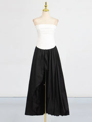 Mannequin wearing a white strapless top and black wide-leg pants on a white background