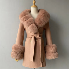 Pink coat with fur trim on a mannequin against a gray background