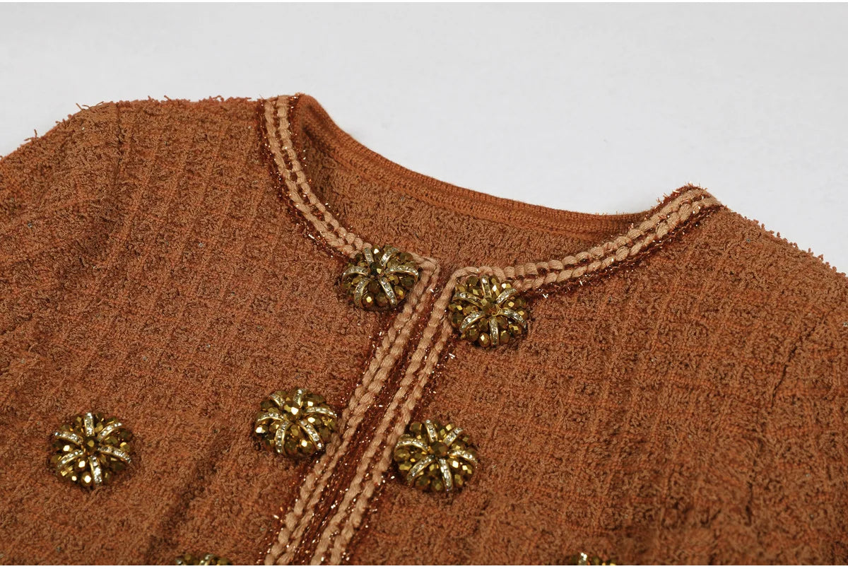 Brown textured fabric with gold buttons on a plain background