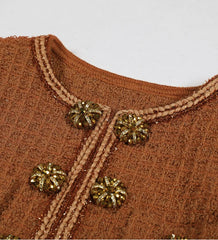 Brown textured fabric with gold buttons on a plain background