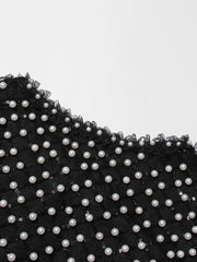 Black lace trim with white pearls on a white background