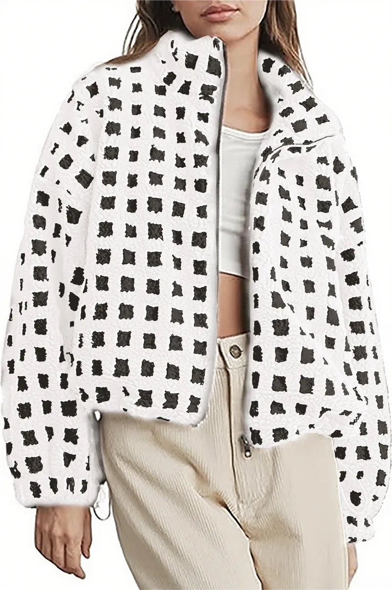 Person wearing a white jacket with black abstract pattern