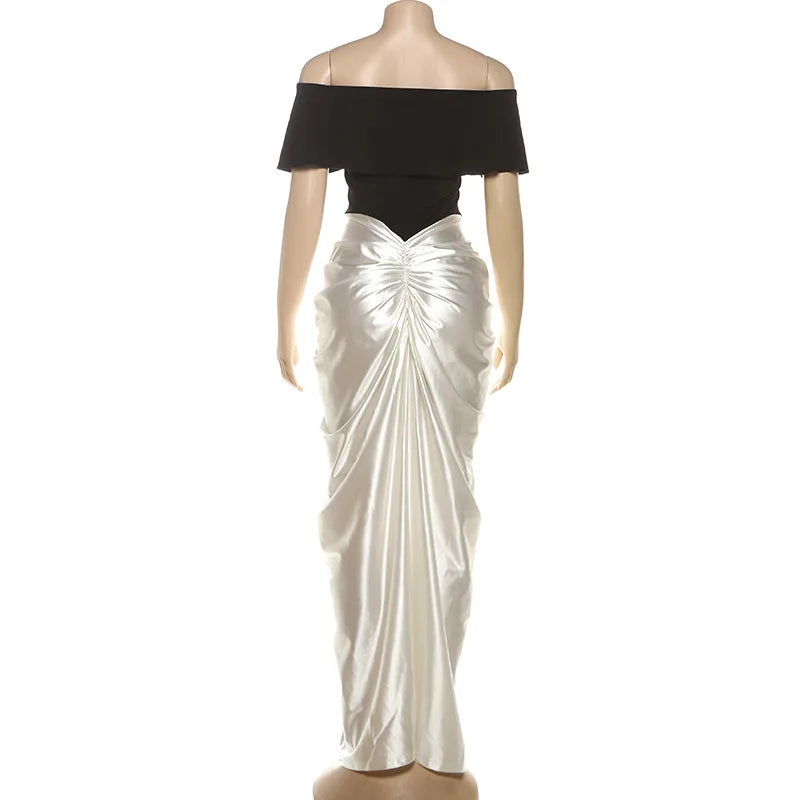 Mannequin wearing a black top and white ruched skirt- Back
