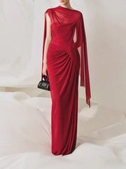 Red draped one-shoulder maxi dress with sheer capelet