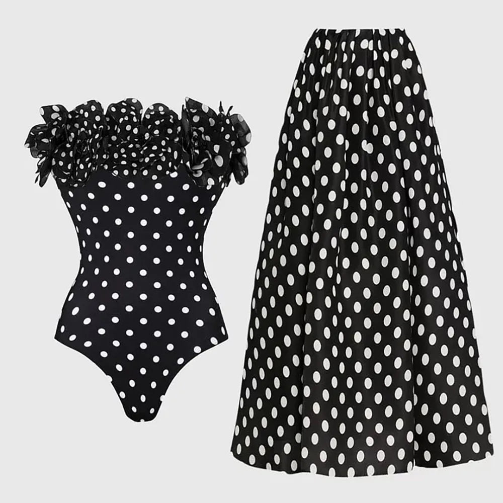 Off-the-shoulder ruffled polka dot one-piece swimsuit and maxi skirt set laid flat.