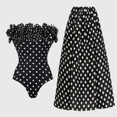 Off-the-shoulder ruffled polka dot one-piece swimsuit and maxi skirt set laid flat.