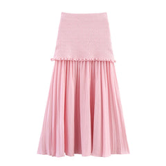 Pink skirt with textured top and pleated bottom on a white background