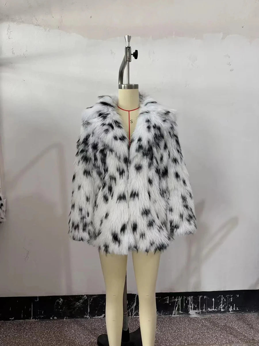 Faux fur coat with black and white pattern on a mannequin against a plain background
