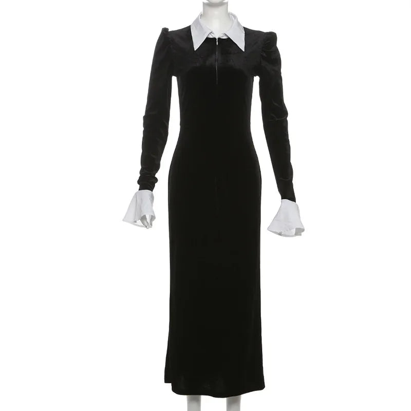 Black dress with white collar and cuffs on a mannequin against a white background