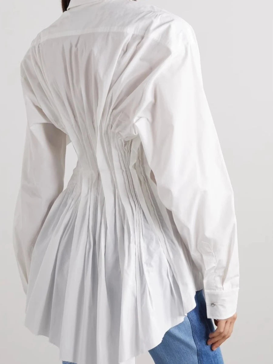 White long-sleeve shirt with pleated design on a plain background